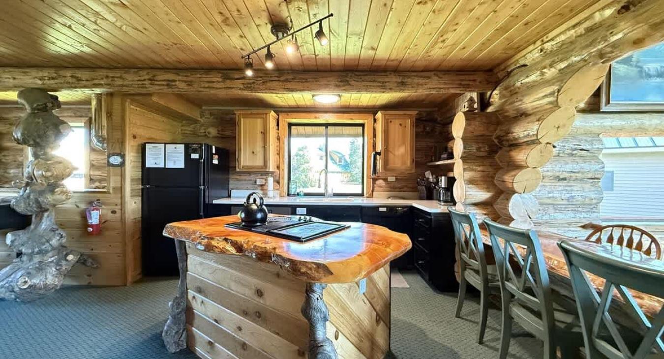 The kitchen in the cabin is a perfect blend of rustic charm and modern convenience, creating a warm and inviting space for cooking, gathering, and enjoying meals.