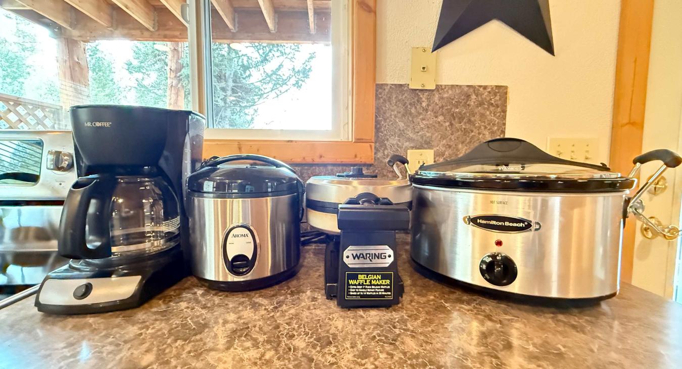 Coffee pot, rice cooker, Belgian waffle maker and crock pot provided for your stay at Timber Heights Cabin. 