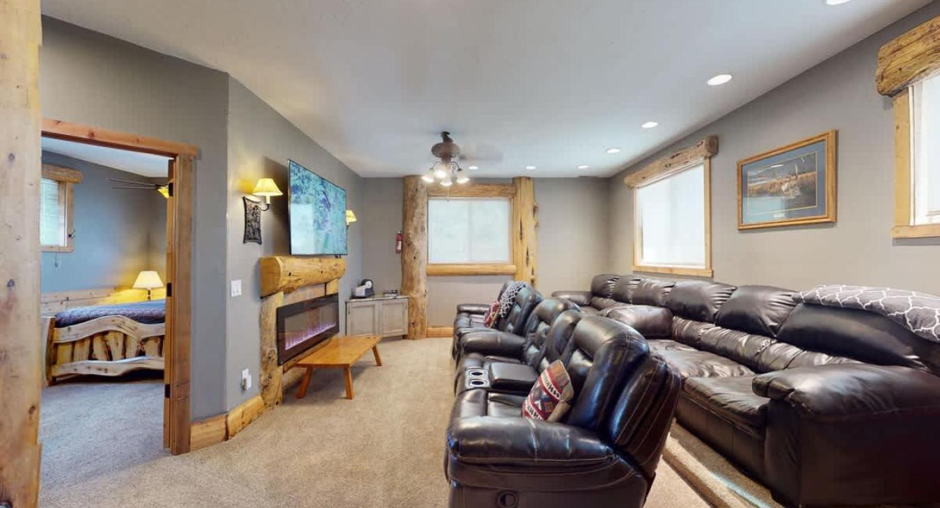 Upstairs living area with seating, fireplace, and tv for entertainment.