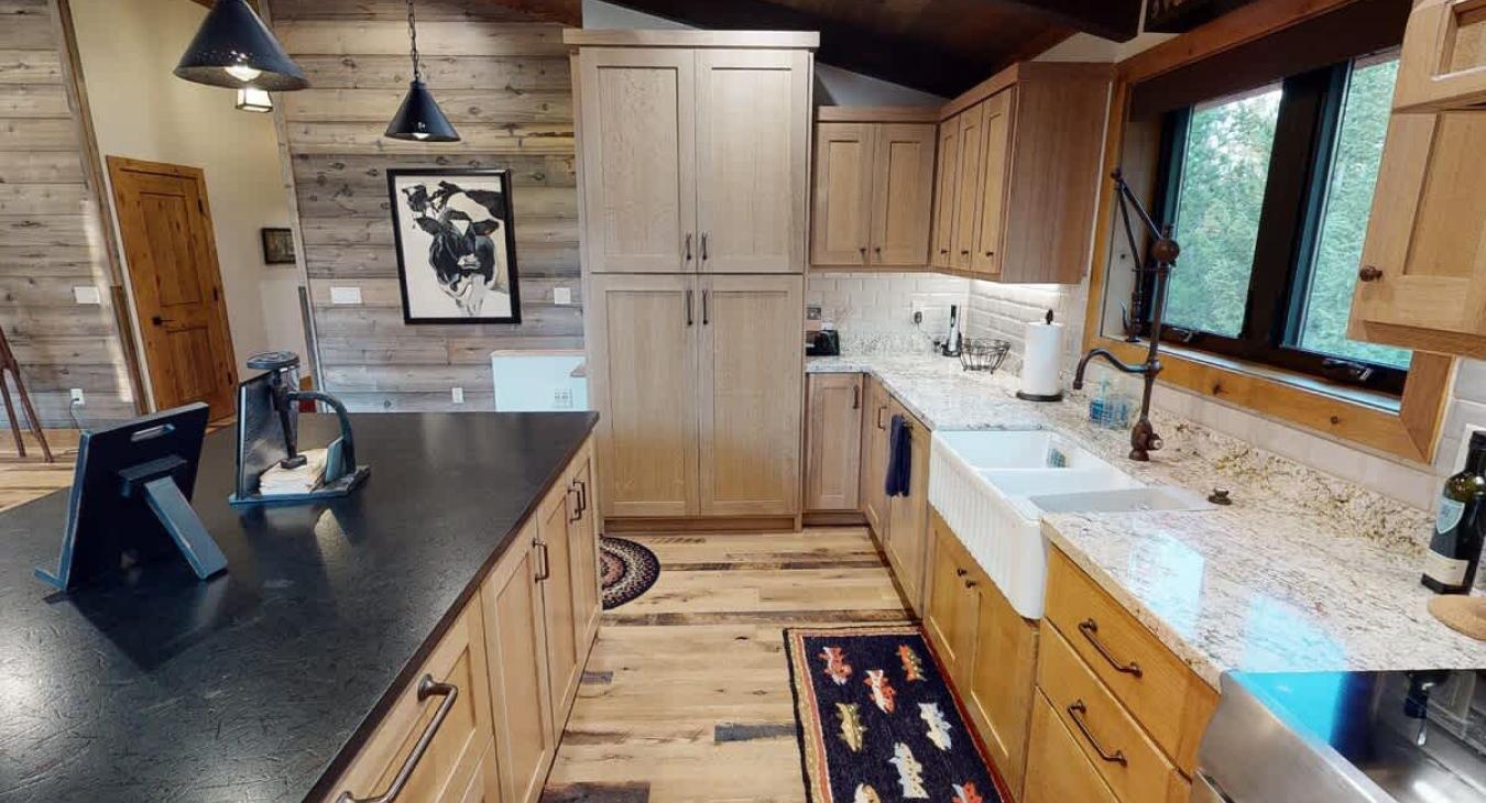 Another side view of the kitchen showcasing the cupboard and counter space.