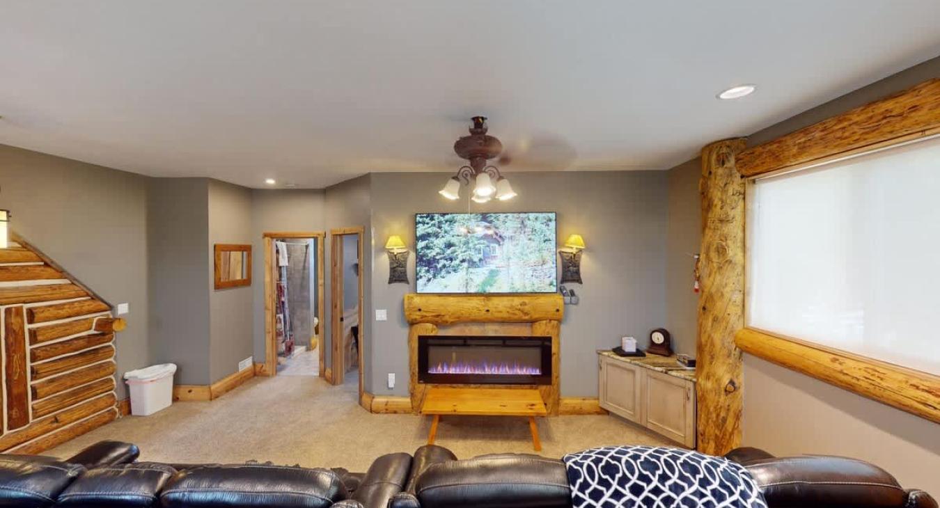 Relax by the fire in this open living room.