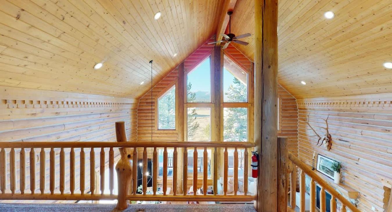 Upstairs loft area with natural light from the windows.