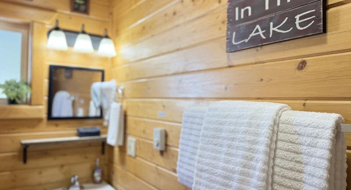 The second bathroom is equipped with a standing shower, sink, and a toilet.