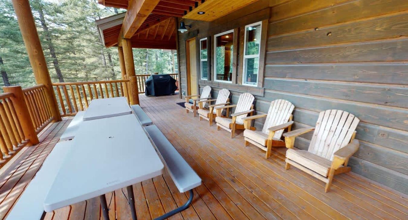 Large deck with seating and a table to enjoy your meals with beautiful views.