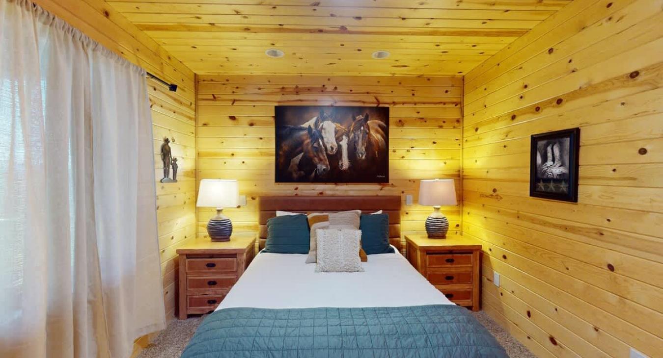 On both sides of the bed there is nightstands with lamps to give the room more light.