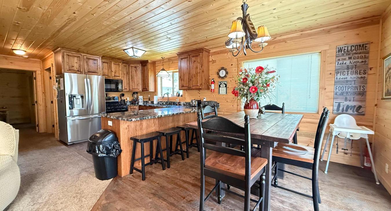 Gather everyone together at the rustic wooden dining table, complete with additional seating at the convenient kitchen breakfast bar stools.