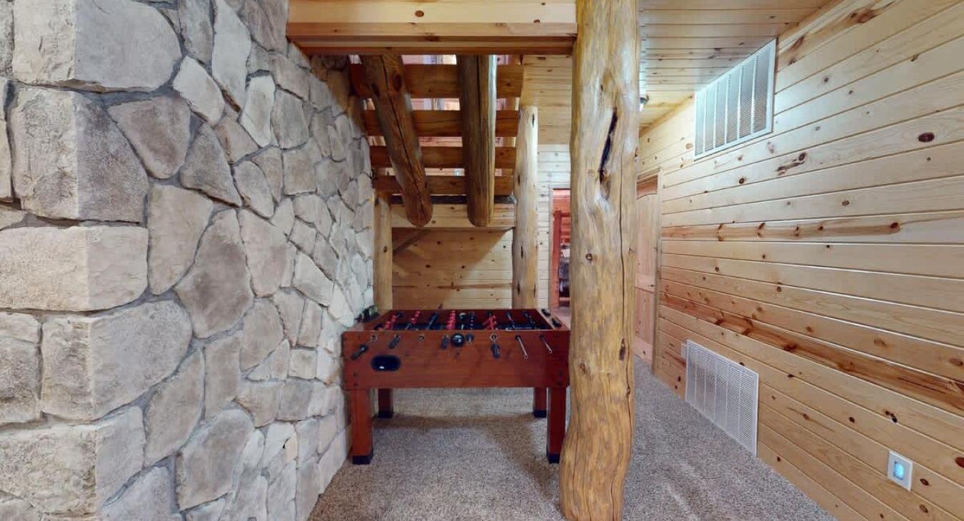 In another corner of the room, a foosball table stands, ready for action. It’s a great spot for friendly competition, and its classic design adds a fun, nostalgic feel to the room.