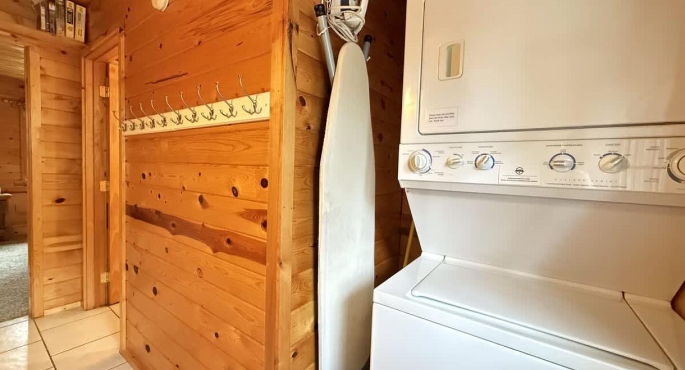 Mud room area on the main level with stacked washer and dryer. Laundry soap is provided.