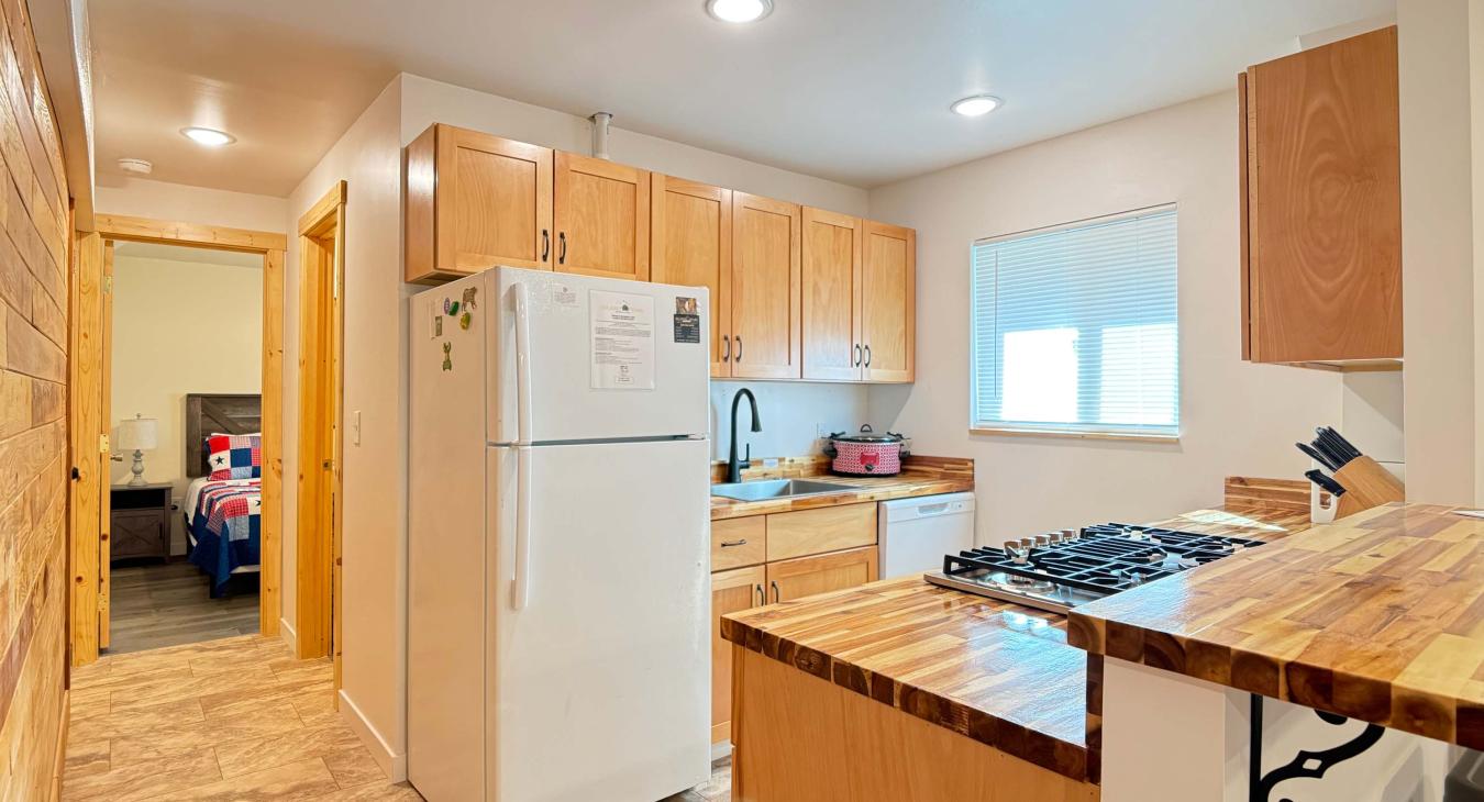 Kitchen leads into the hallway with the bathroom on the right and master bedroom strait back.