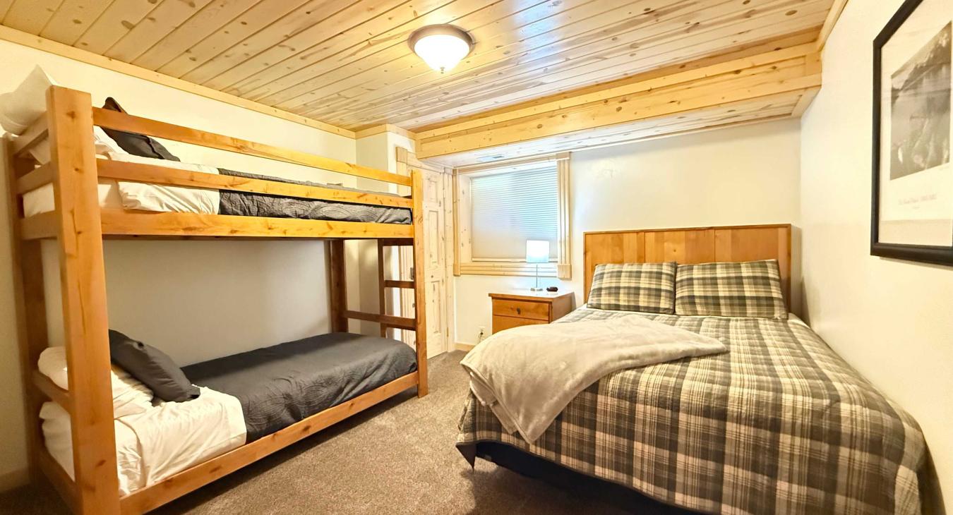 Bedroom #4 located downstairs with Queen and bunk bed.