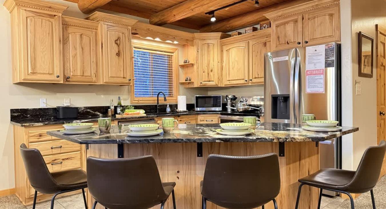 Fully equipped kitchen with appliances, cookware, dishes, utensils, and some basic spices.