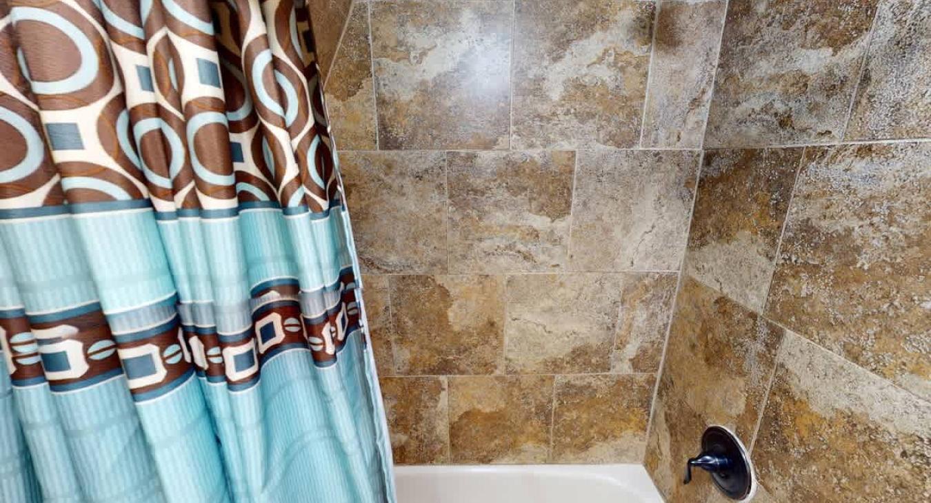 The shower and tub combo located in the bathroom.