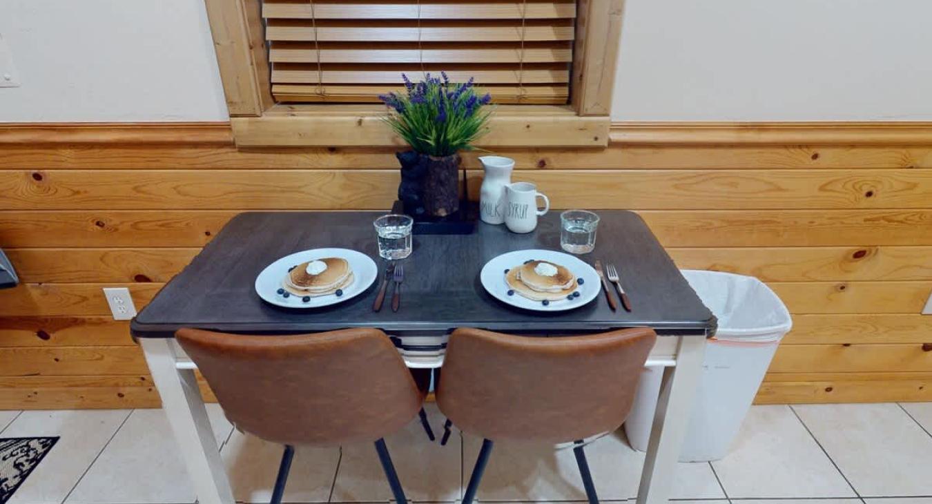 A small but comfortable dining room table to comfortably seat 2 people.