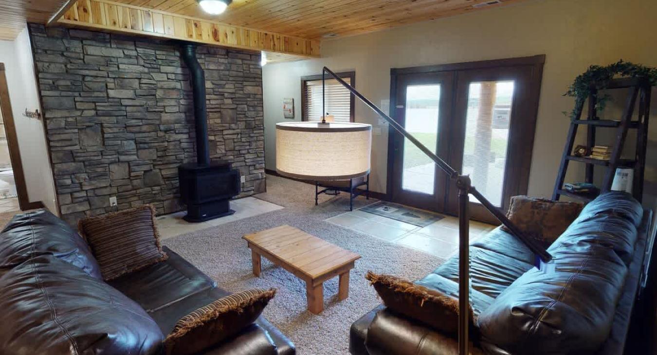 Downstairs living area with fireplace and seating.