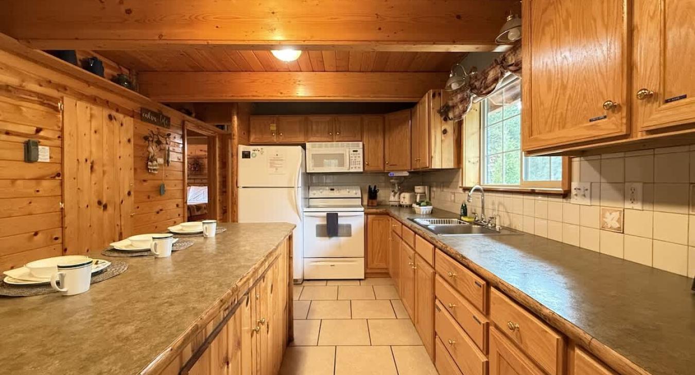 Full size kitchen with appliances, cookware, pots and pans, utensils, dishes, and basic cooking essentials.