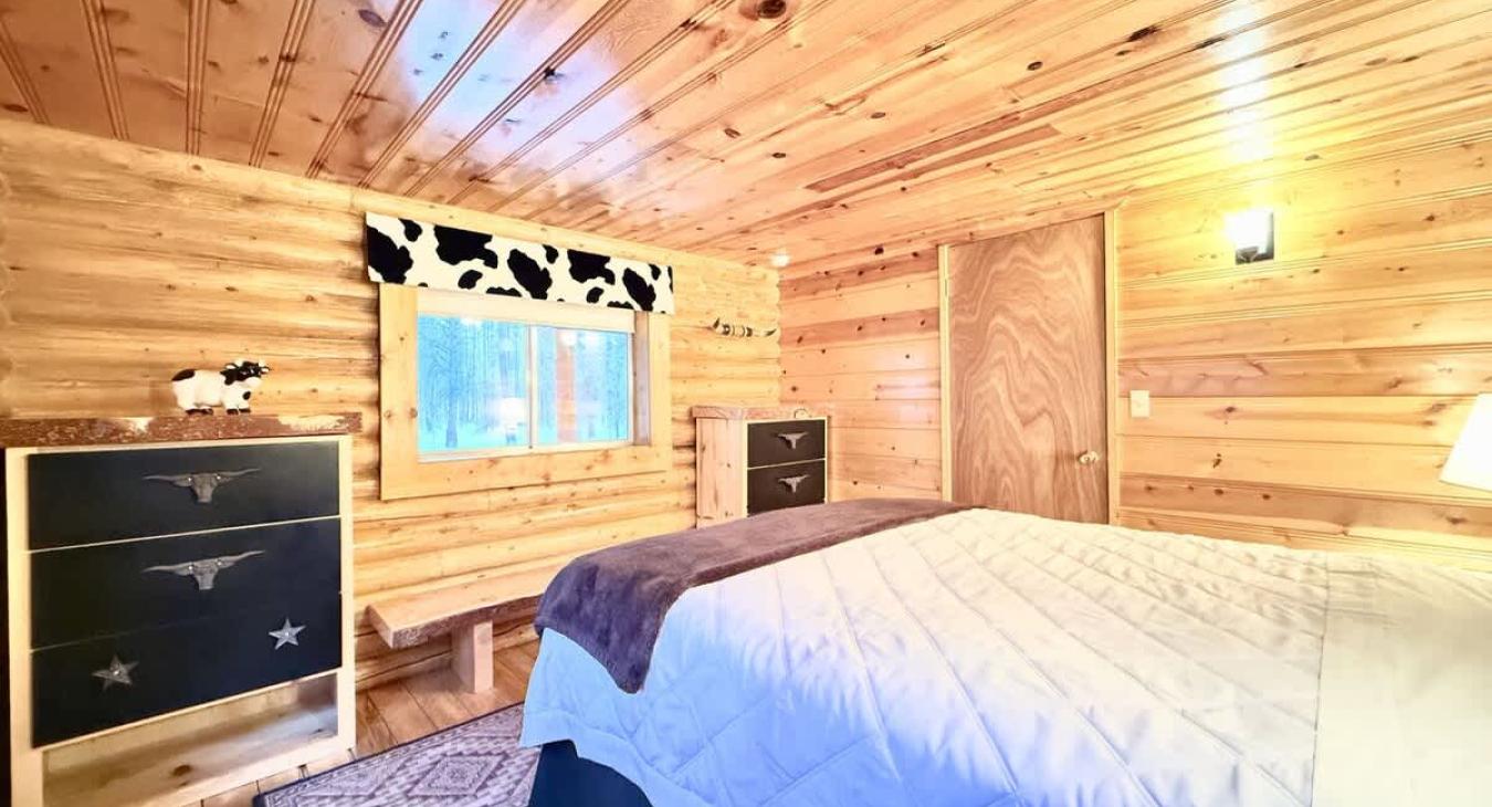 Main floor queen bedroom with clothing storage.