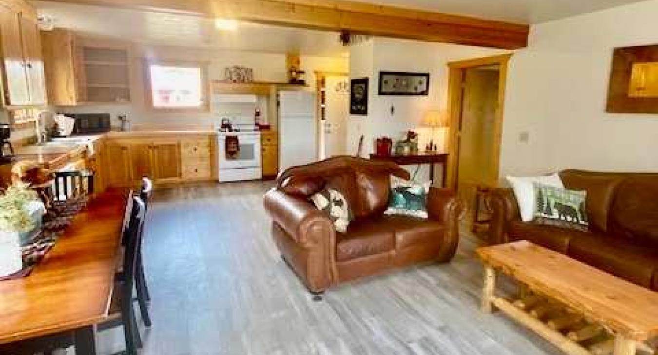 The living room with seating and tv for entertainment.