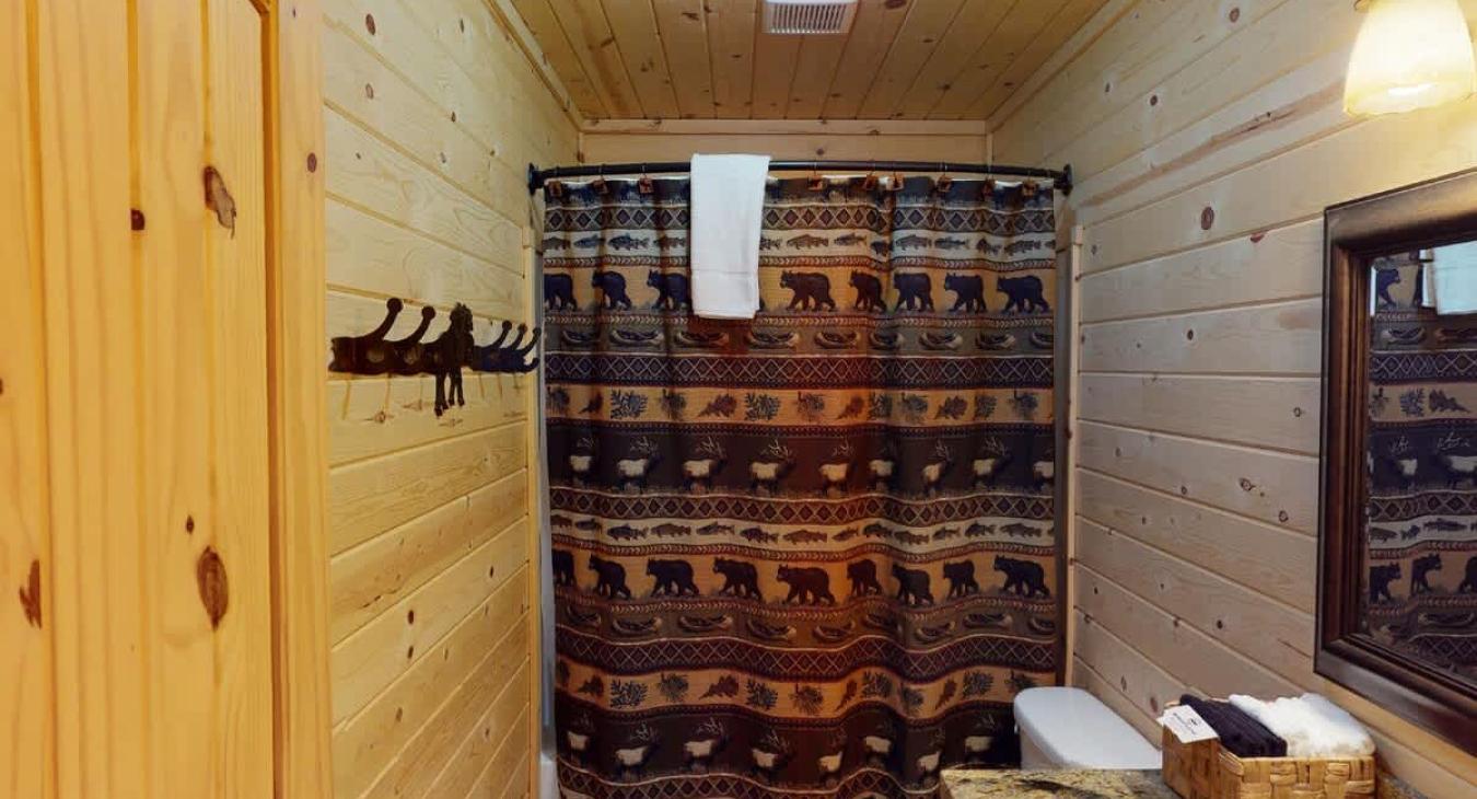 Upstairs bathroom with shower/tub, toilet, and sink.