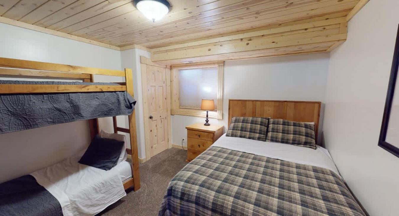 Bedroom #4 located downstairs with Queen and bunk bed.
