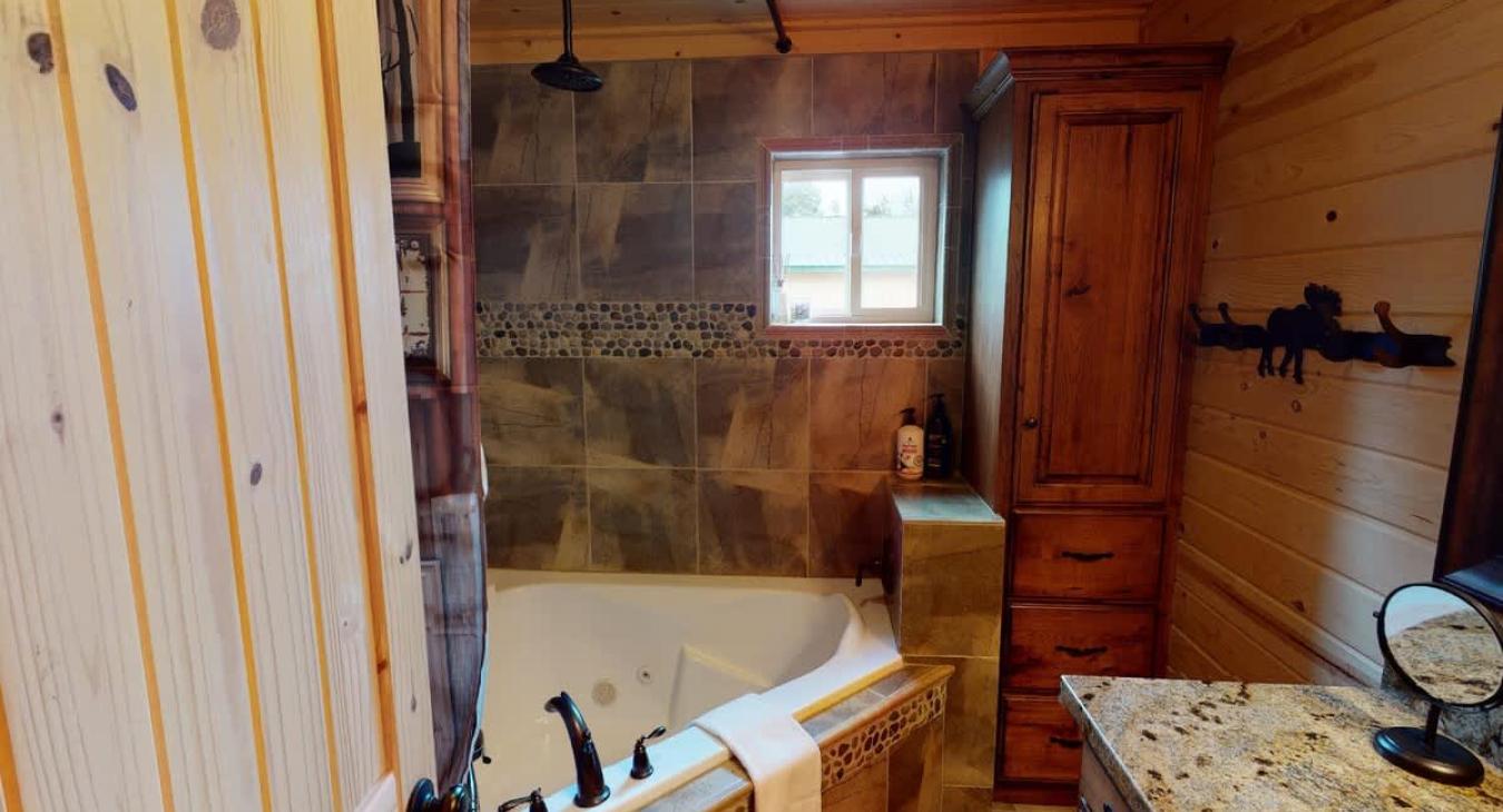 Ensuite bathroom with tub/shower, toilet, and sink.