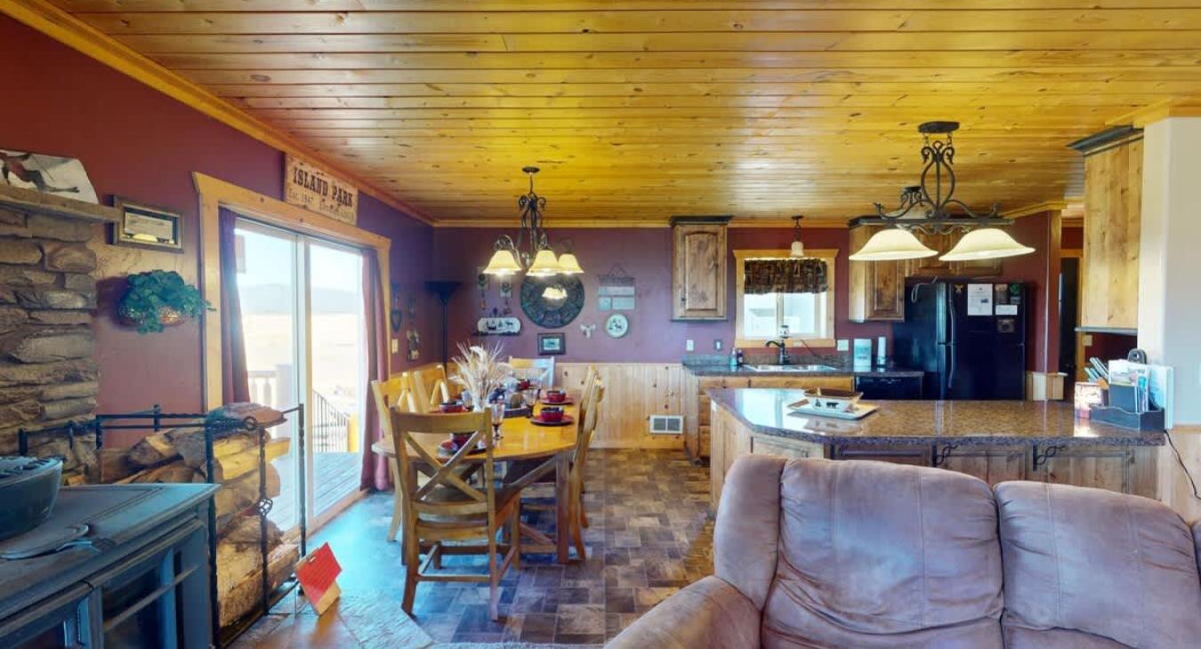 A large dining room table located next to the kitchen.