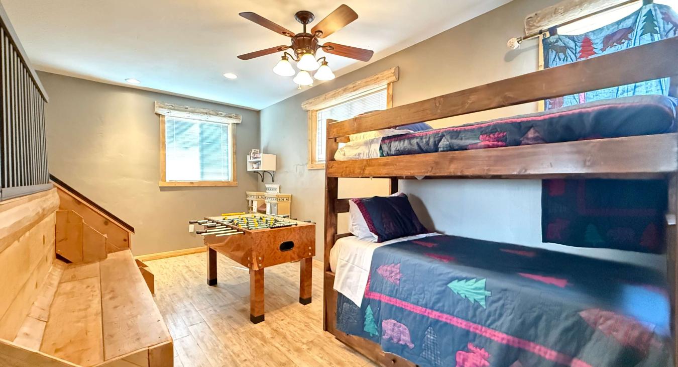 Let the games begin! This incredible space features a premium wooden foosball table right alongside the cozy bunk bed layout.