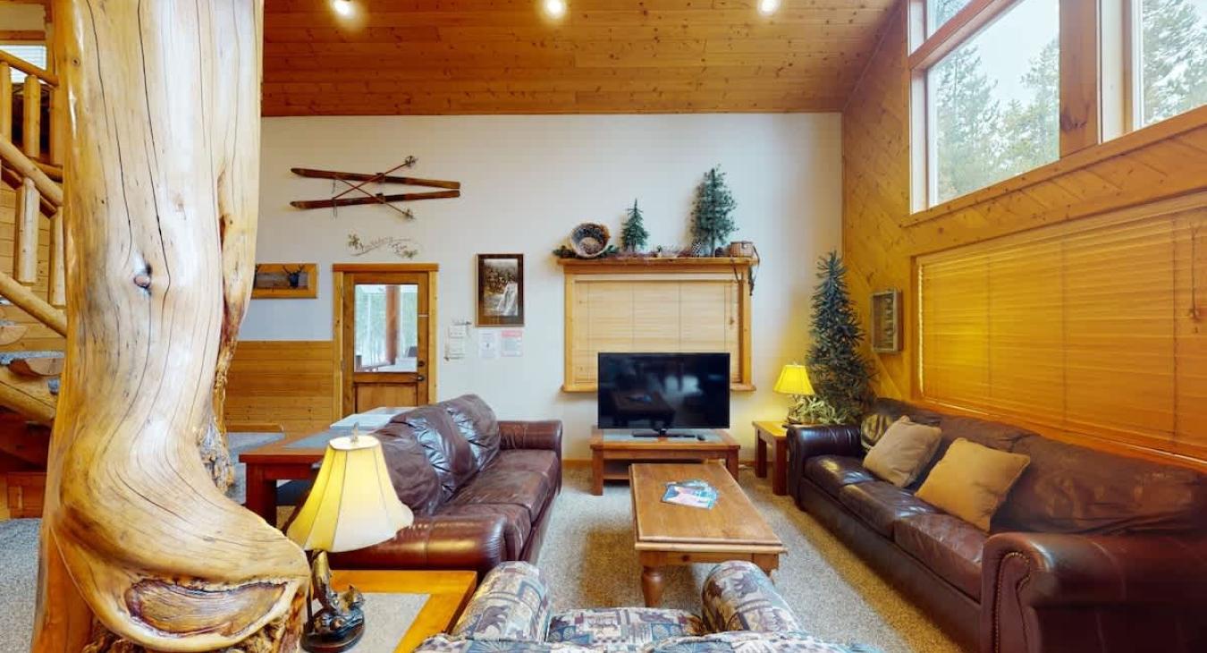 The living room is equipped with seating on the couches and a smart televisions for entertainment.