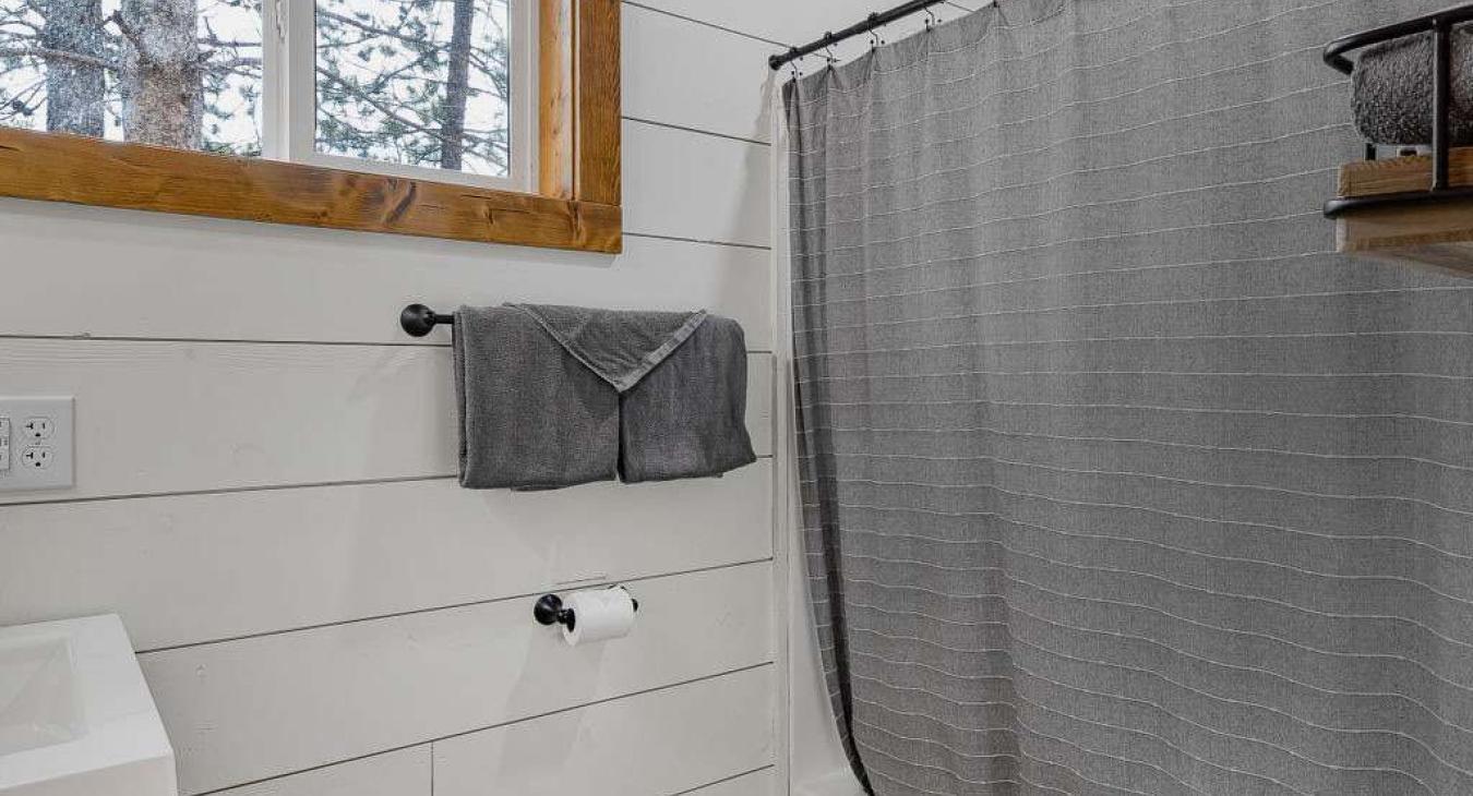 Full size bathroom with hot water on demand and a deep bathtub for soaking.