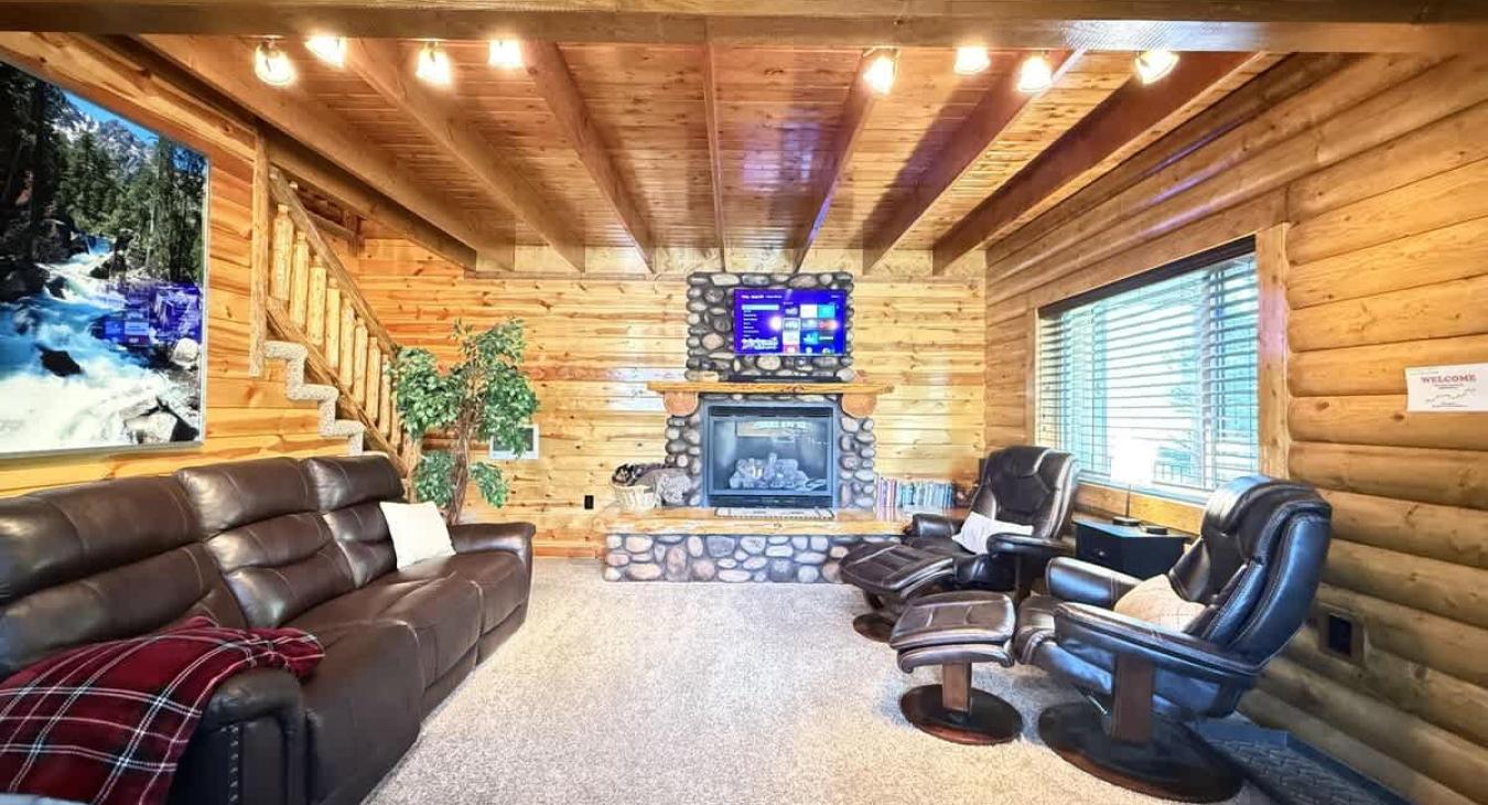 Living room with seating and smart tv for entertainment. Fireplace is also located here to cozy up by the fire.