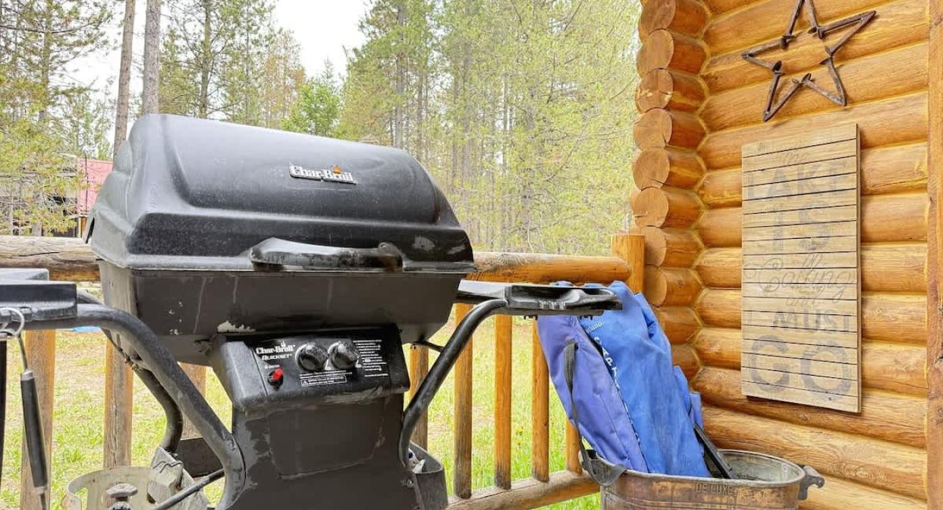 A propane grill on the front porch.