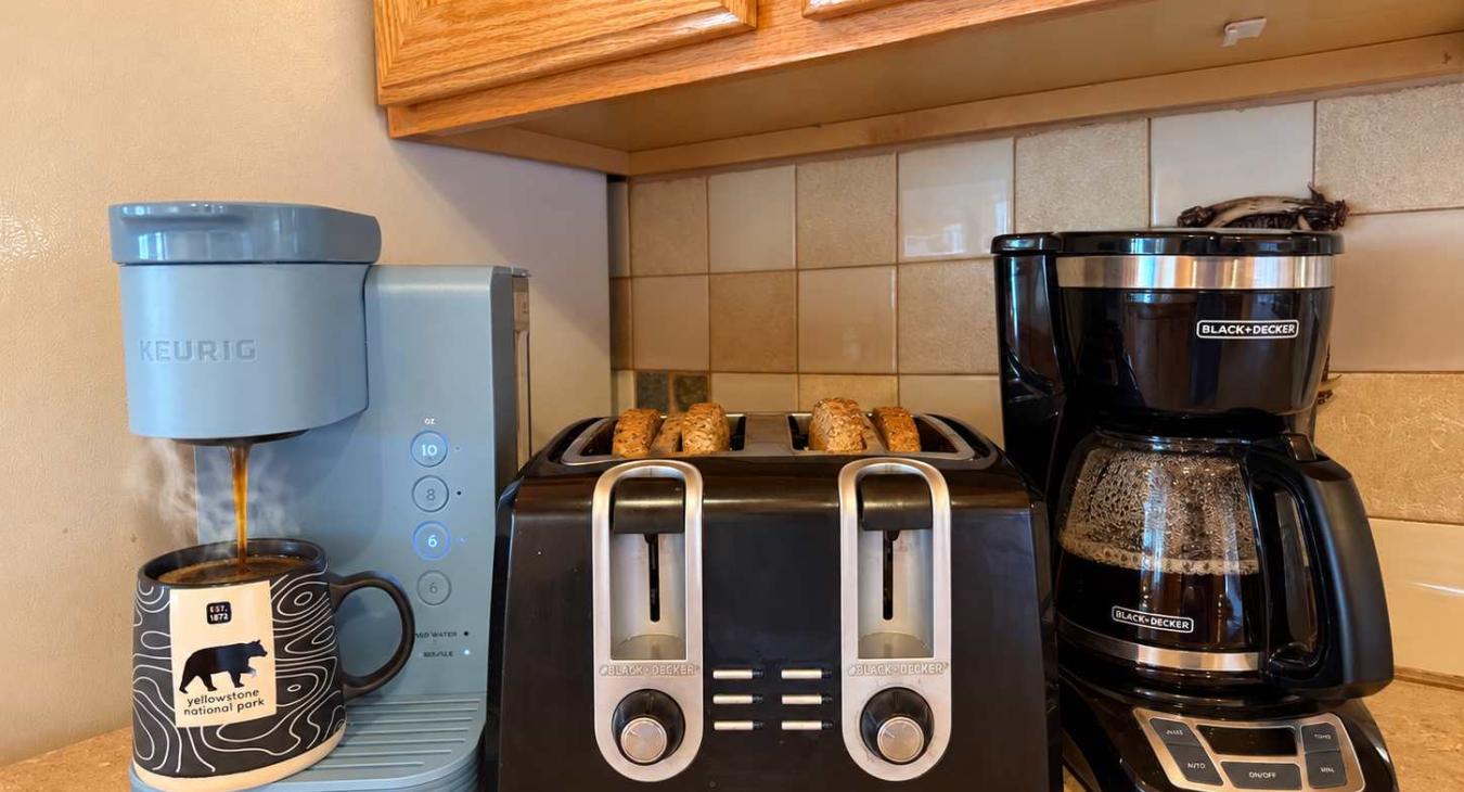 Keurig and standard drip coffee maker and a 4 slot toaster.
