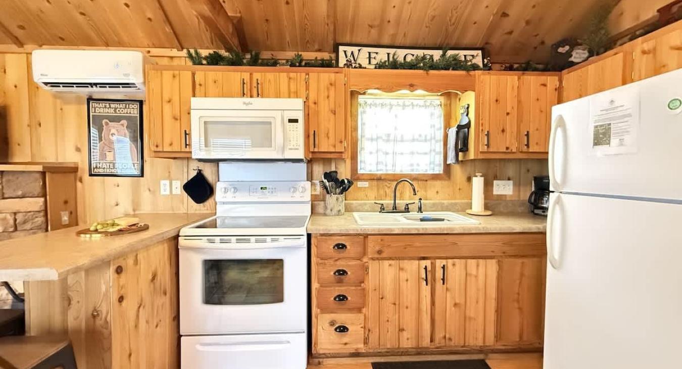 Full kitchen with appliances, cookware, dishes, silverware, and basic spices.