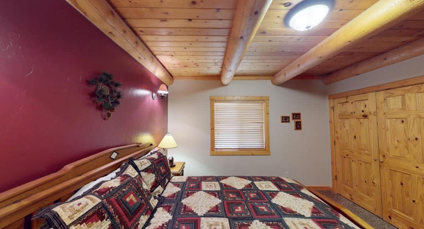 A moderately sized window—framed in wood—lets in morning light and gives a peek at the trees or landscape outside.