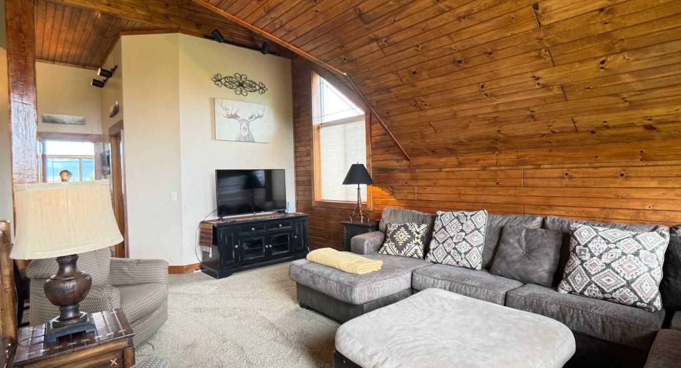 Unwind in the expansive upstairs loft, boasting a massive sectional sofa and a dedicated TV area—perfect for group movie nights.