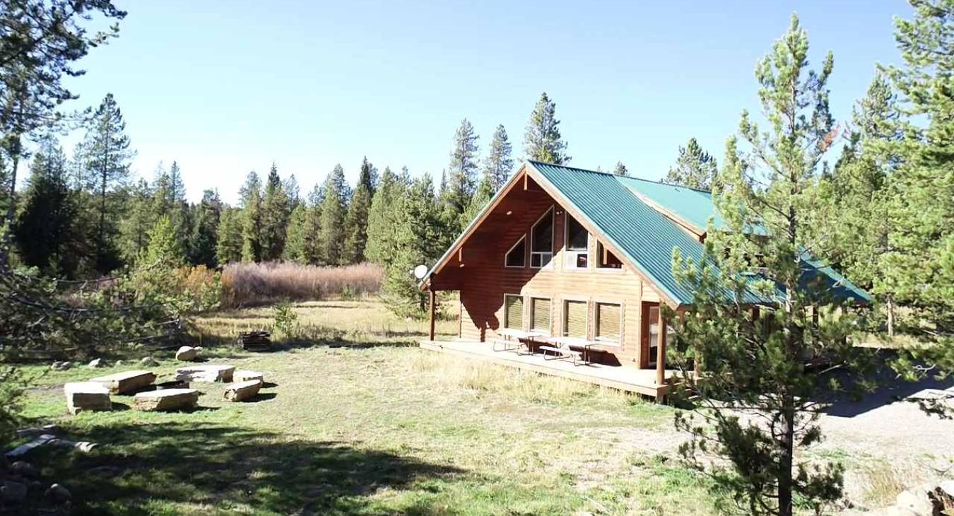 view of the fire pit in front of the cabin.