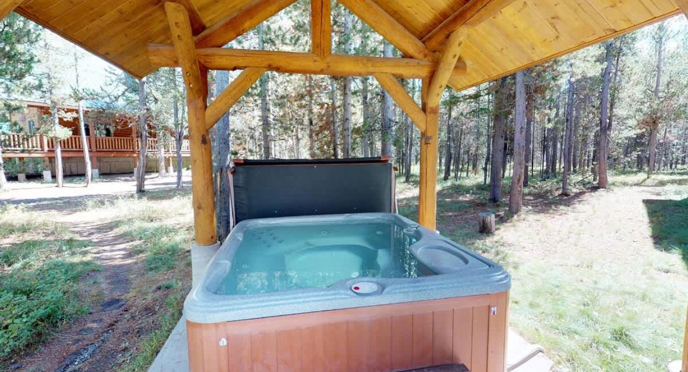 A hot tub is located outside with hot tub towels provided.