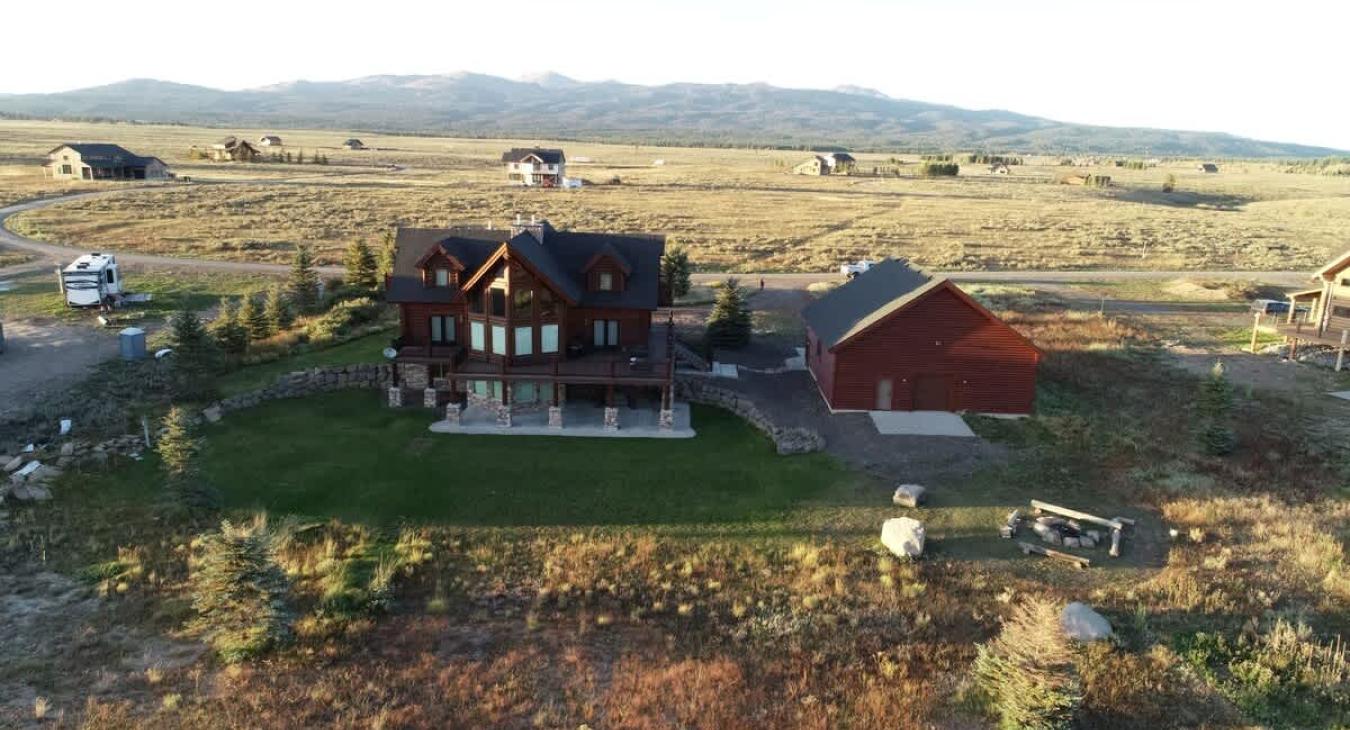 The cabin’s exterior is designed to complement its environment, sitting comfortably amidst the pines that are characteristic of Island Park.