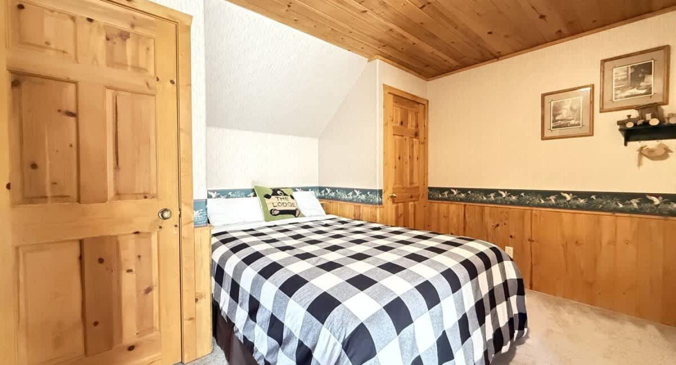 Queen size bed located in the garage apartment.