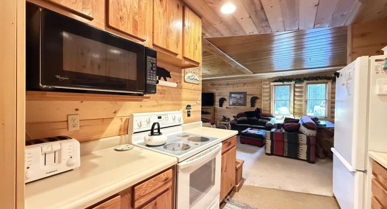 Another view of the full galley kitchen. Electric range and microwave.