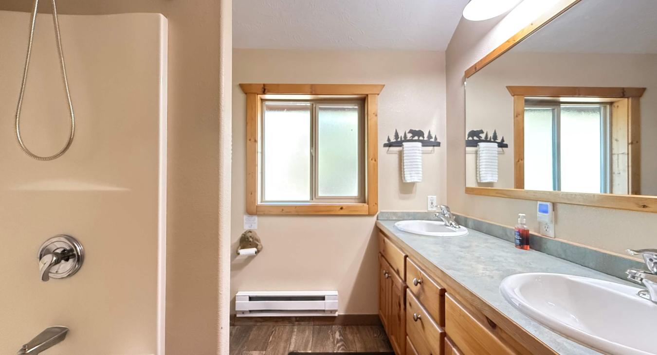 Bathroom #3 located upstairs with shower/tub, toilet, and double sinks.