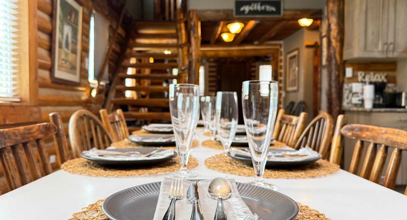 Host memorable family dinners at the large rustic dining table, perfectly set with beautiful tableware right next to the log staircase.