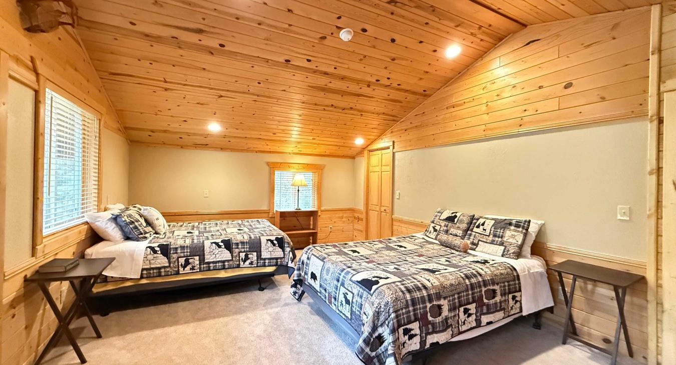 Second upstairs bedroom with 2 queen beds and balcony. 