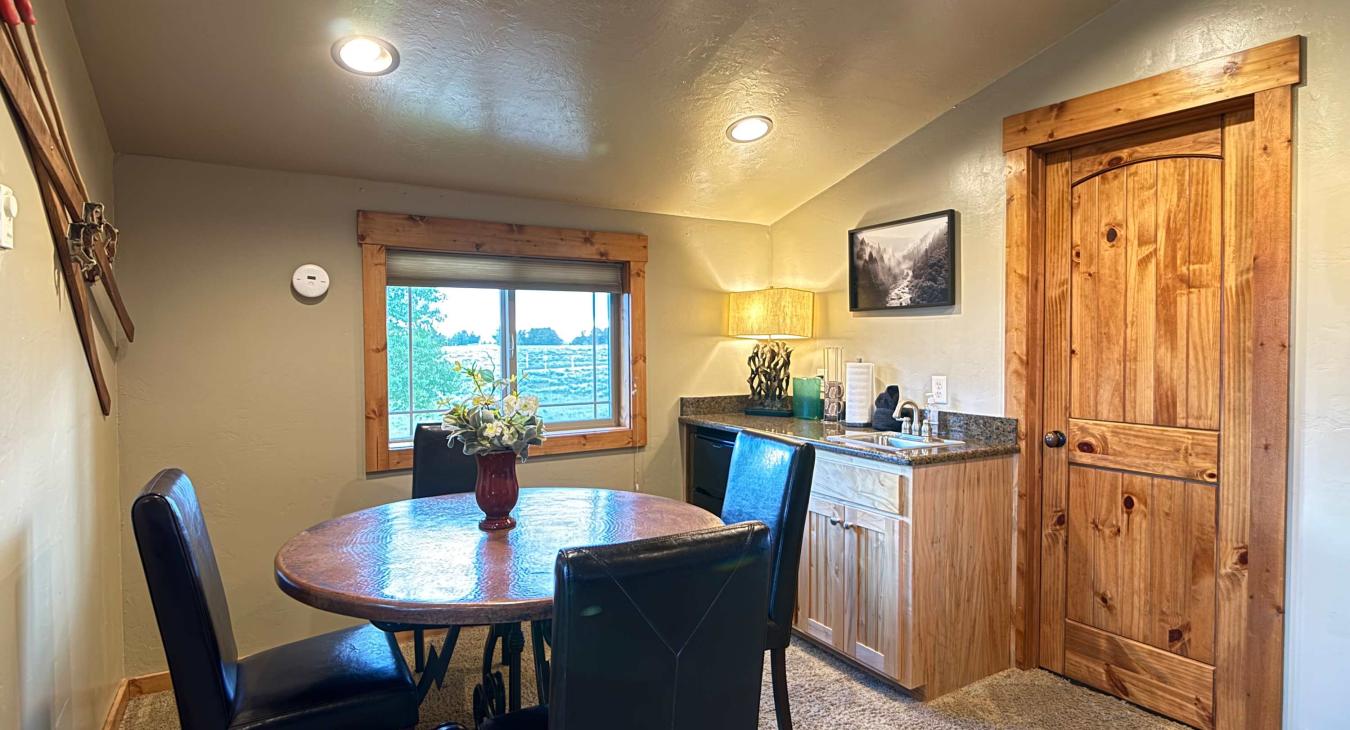 Enjoy light meals or snacks at the round dining table, conveniently complete with a handy wet bar kitchenette and mini-fridge.