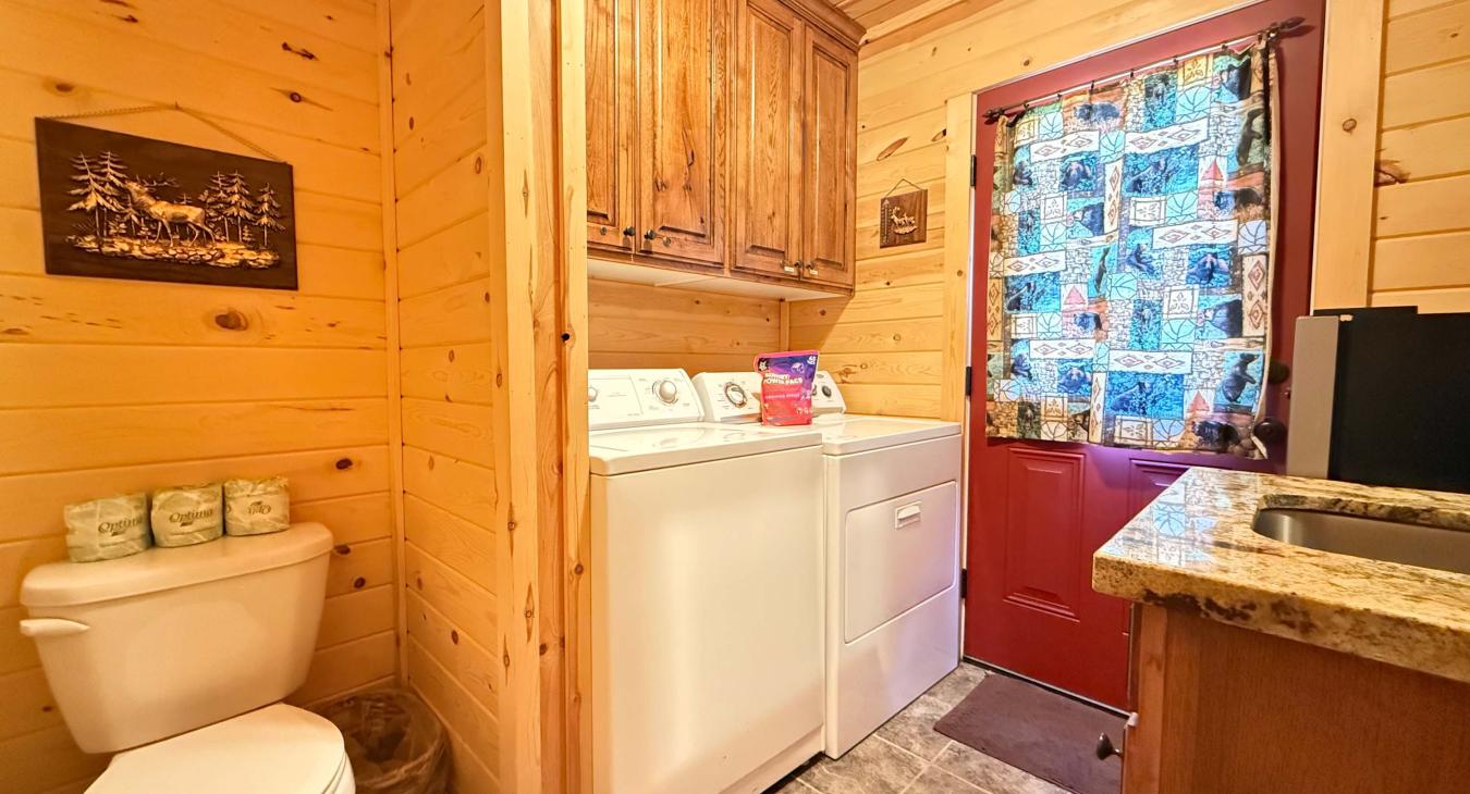 For your ultimate convenience, this efficient utility space features a stacked washer and dryer right alongside a clean toilet and a premium granite-top vanity.