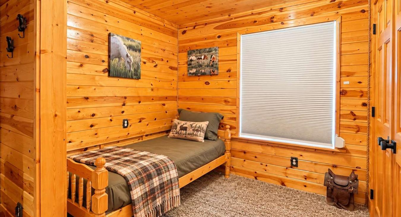This is a spacious bedroom on the main level with a queen bed and a nook with a twin bed.