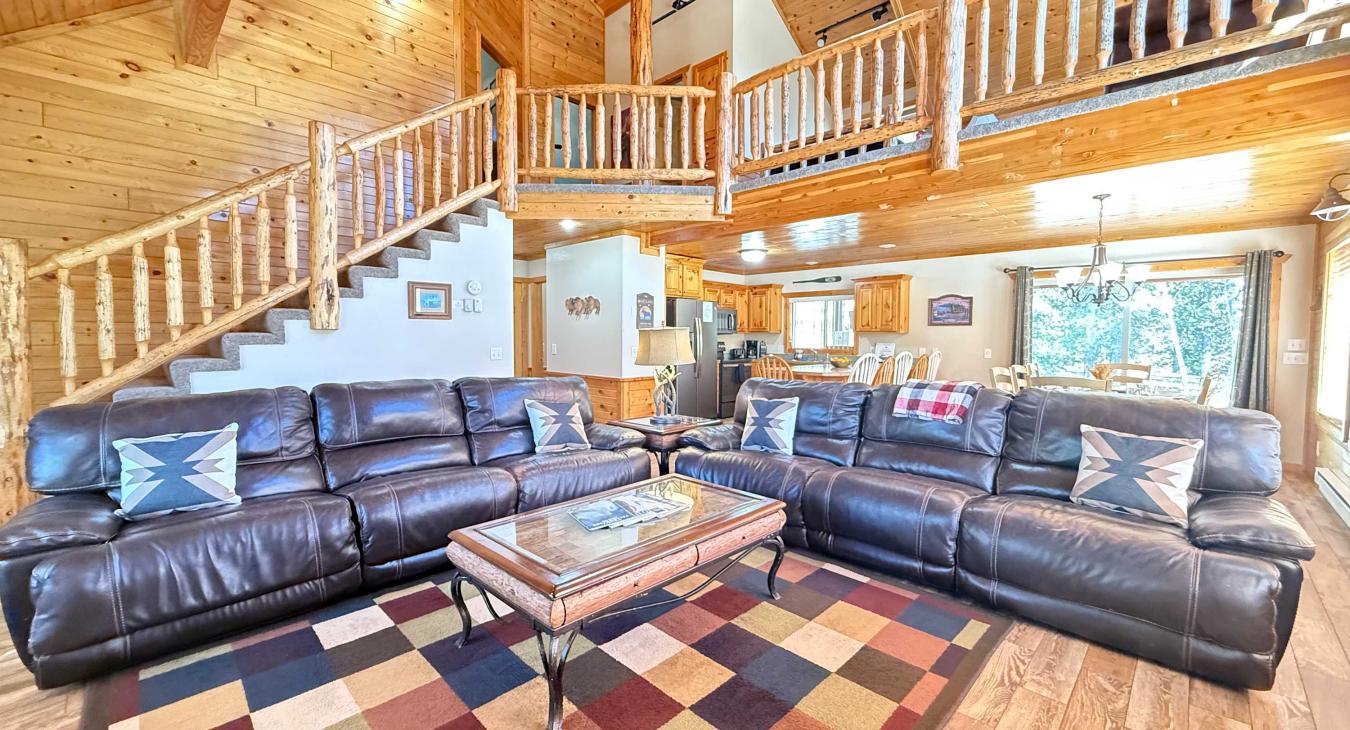 The open kitchen blends seamlessly into the cabin's cozy living area, creating a welcoming space perfect for gathering and unwinding.