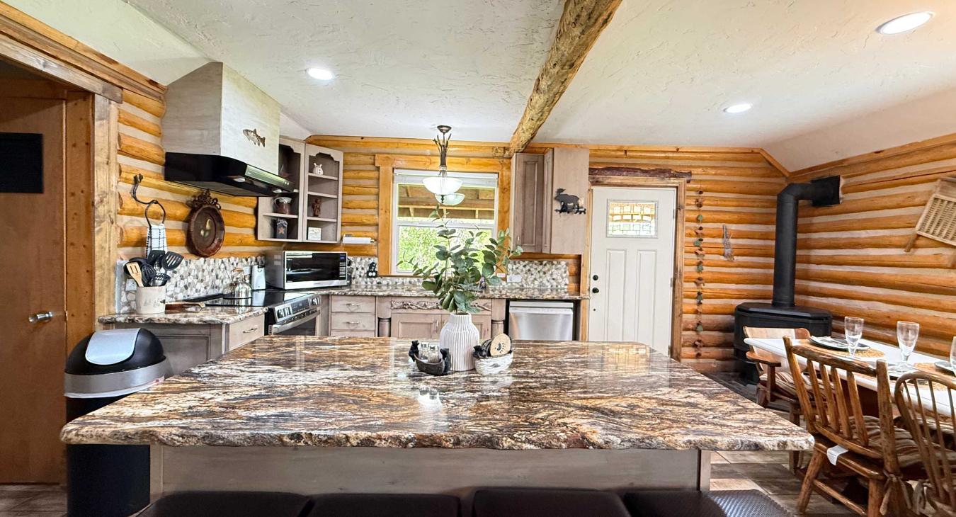 Whip up delicious family meals in the expansive kitchen, featuring a massive premium granite island with comfortable leather-cushioned barstools.