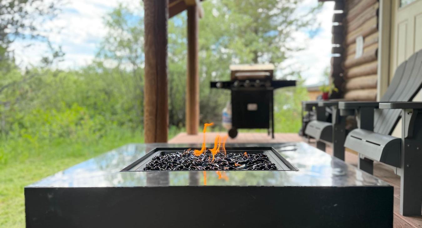 Cozy up around the premium propane gas fire pit table on the deck, providing a clean, warm fire at the flip of a switch.