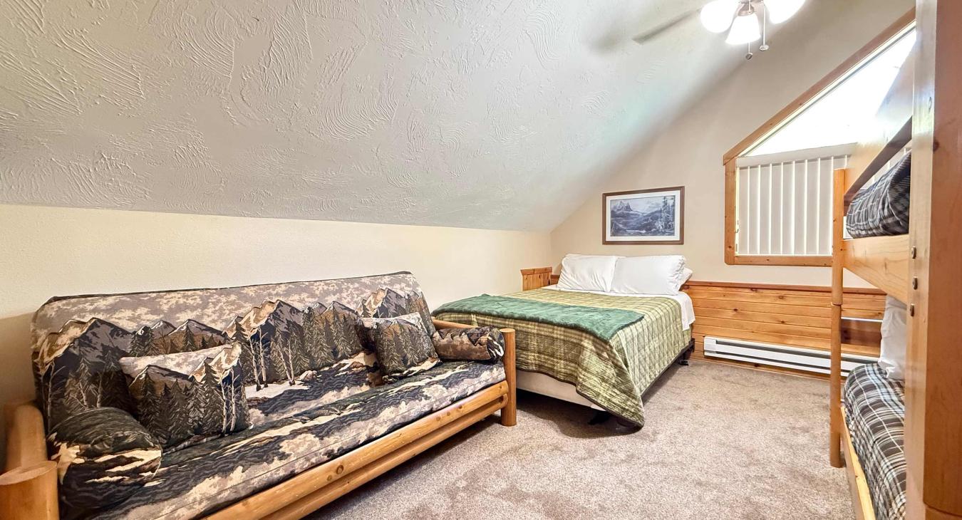 Bedroom #2 located upstairs with 1 Queen bed and 2 twins on the bunk bed.