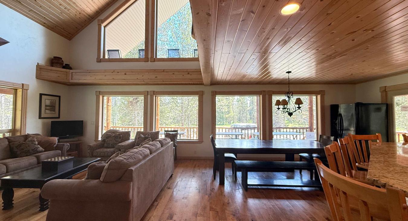 The open kitchen blends seamlessly into the cabin's cozy living area, creating a welcoming space perfect for gathering and unwinding.